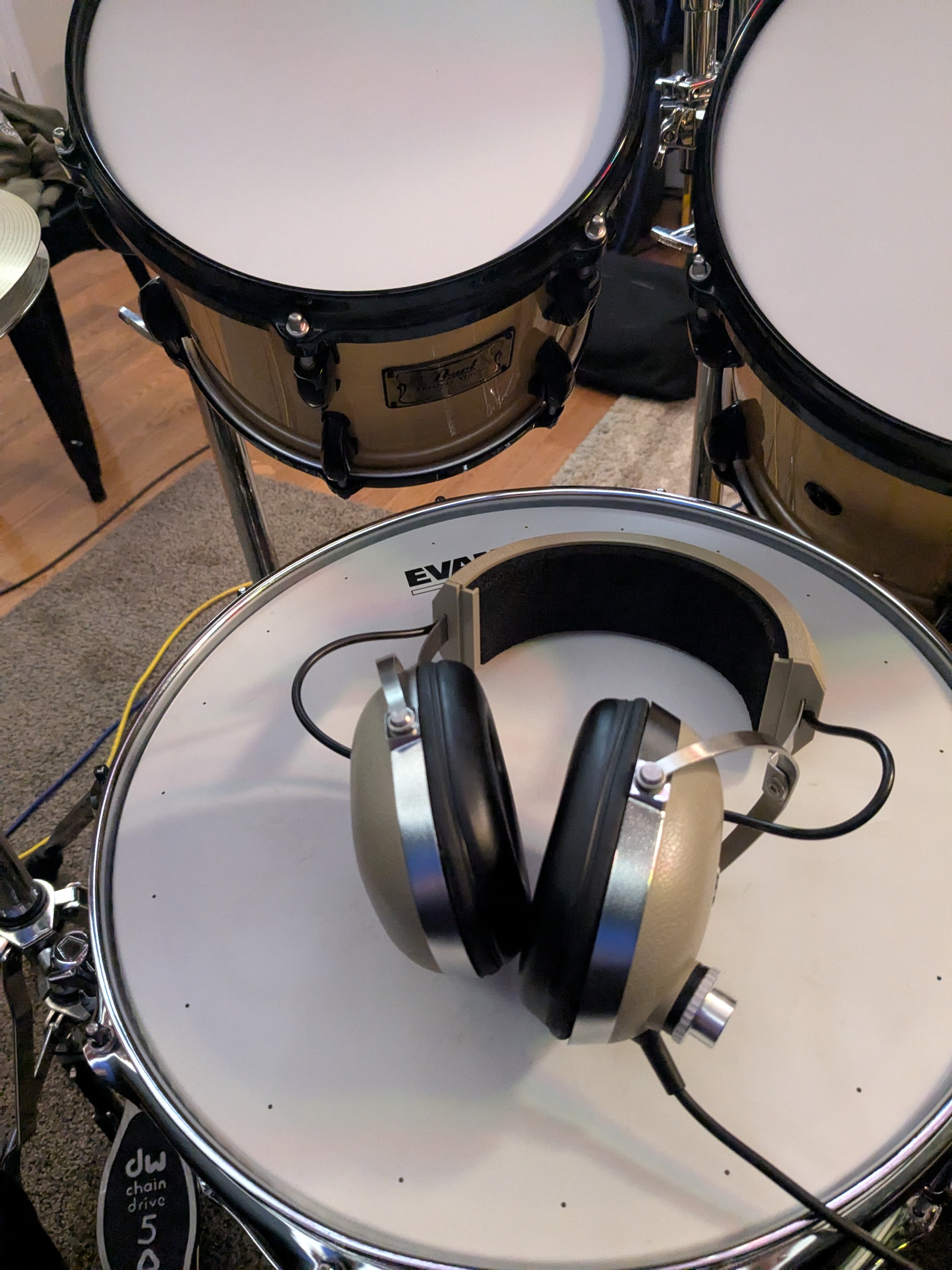 Drum kit with headphones resting on the bass drum head